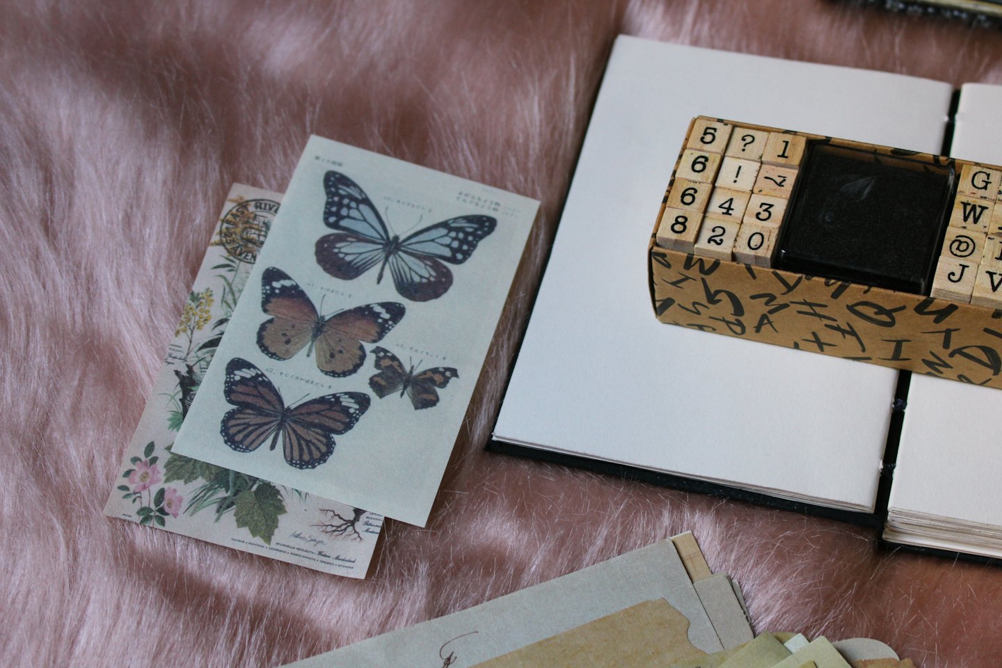Journaling supplies including vintage papers, stamps, and an open notebook.