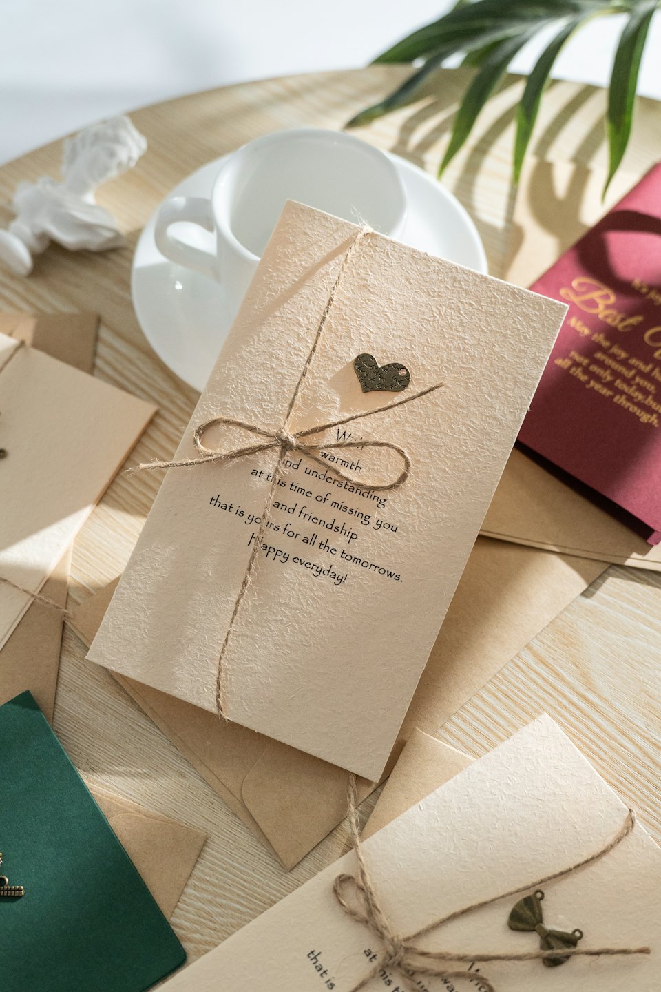 Handcrafted greeting cards arranged on a wooden table.